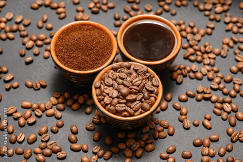 Three cups with different coffee  coffee beans  ground and ready-made drink.