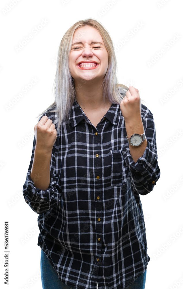 Young blonde woman over isolated background very happy and excited doing winner gesture with arms raised, smiling and screaming for success. Celebration concept. Young blonde woman over isolated background very happy and excited doing winner gesture with arms raised, smiling and screaming for success. Celebration concept.