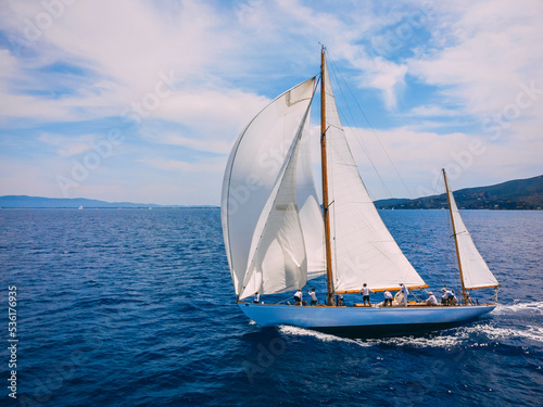 Classic wooden yacht sailing with crew in regatta in the Mediterranean sea.