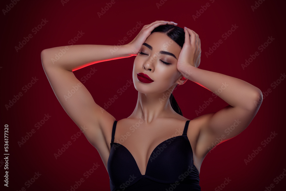 Photo of attractive rich lady touch hairstyle wealthy occasion wear cleavage outfit isolated maroon color background Photo of attractive rich lady touch hairstyle wealthy occasion wear cleavage outfit isolated maroon color background