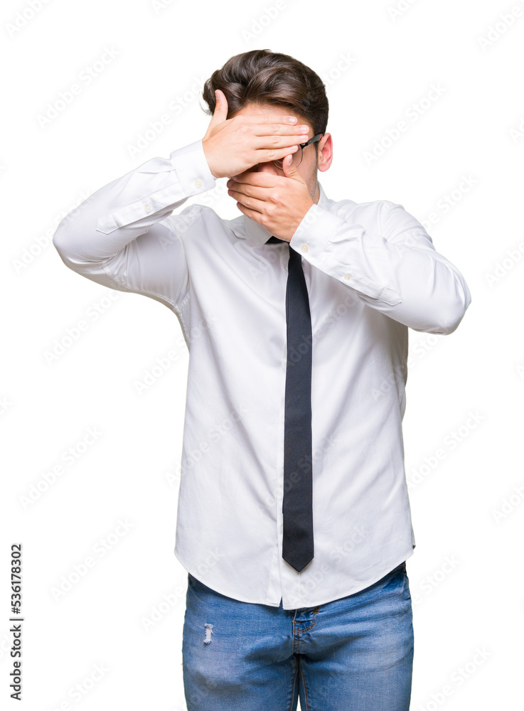 Young business man wearing glasses over isolated background Covering eyes and mouth with hands, surprised and shocked. Hiding emotion Young business man wearing glasses over isolated background Covering eyes and mouth with hands, surprised and shocked. Hiding emotion