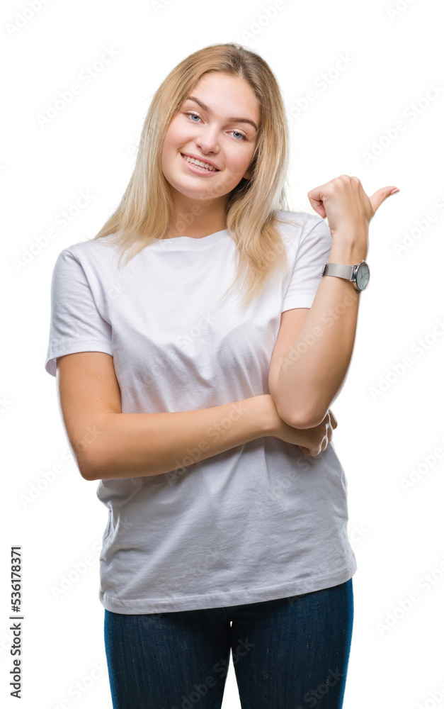 Young caucasian woman over isolated background smiling with happy face looking and pointing to the side with thumb up. Young caucasian woman over isolated background smiling with happy face looking and pointing to the side with thumb up.