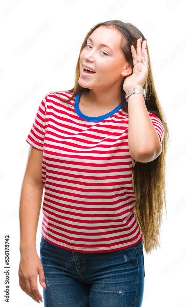 Young caucasian beautiful woman over isolated background smiling with hand over ear listening an hearing to rumor or gossip. Deafness concept. Young caucasian beautiful woman over isolated background smiling with hand over ear listening an hearing to rumor or gossip. Deafness concept.