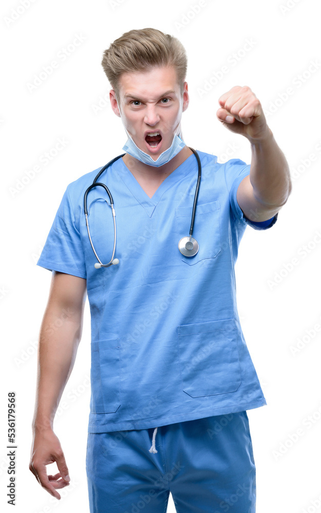 Young handsome blond doctor annoyed and frustrated shouting with anger, crazy and yelling with raised hand, anger concept Young handsome blond doctor annoyed and frustrated shouting with anger, crazy and yelling with raised hand, anger concept