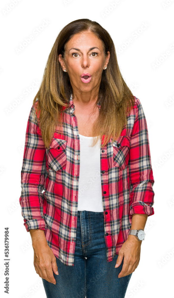 Middle age adult woman wearing casual shirt over isolated background afraid and shocked with surprise expression, fear and excited face. Middle age adult woman wearing casual shirt over isolated background afraid and shocked with surprise expression, fear and excited face.