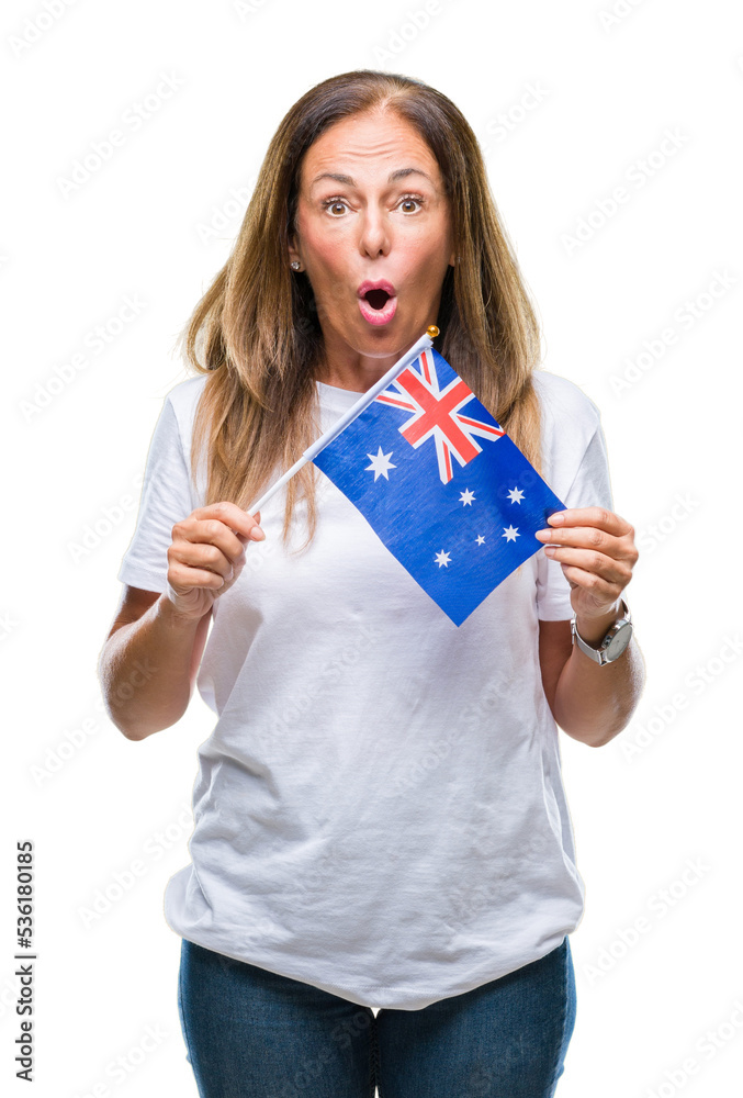 Middle age hispanic woman holding flag of Australia over isolated background scared in shock with a surprise face, afraid and excited with fear expression Middle age hispanic woman holding flag of Australia over isolated background scared in shock with a surprise face, afraid and excited with fear expression