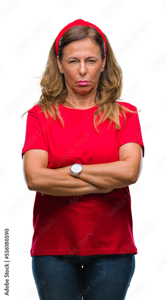 Middle age senior hispanic woman over isolated background skeptic and nervous, disapproving expression on face with crossed arms. Negative person. Middle age senior hispanic woman over isolated background skeptic and nervous, disapproving expression on face with crossed arms. Negative person.