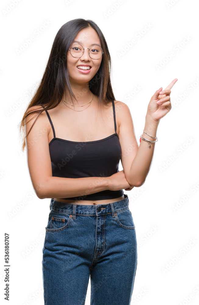 Young asian woman wearing glasses over isolated background with a big smile on face, pointing with hand and finger to the side looking at the camera. Young asian woman wearing glasses over isolated background with a big smile on face, pointing with hand and finger to the side looking at the camera.