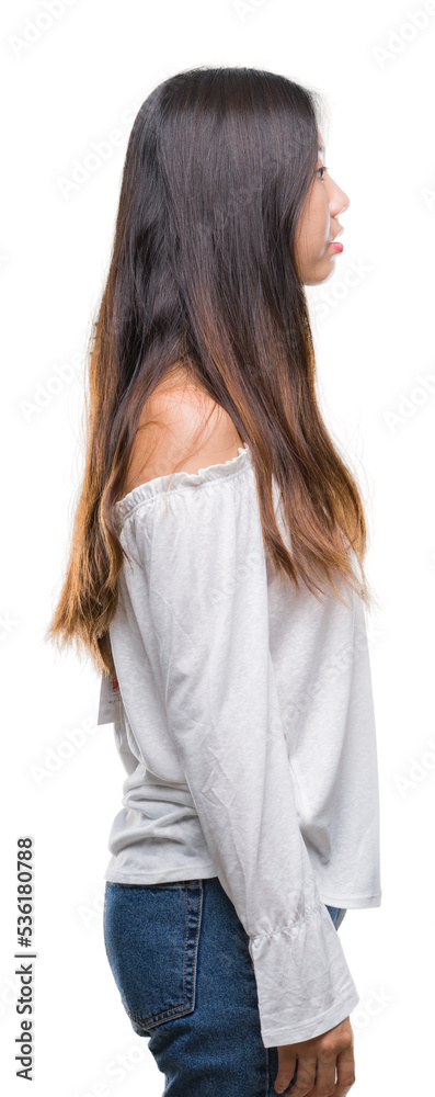 Young asian woman over isolated background looking to side, relax profile pose with natural face with confident smile. Young asian woman over isolated background looking to side, relax profile pose with natural face with confident smile.