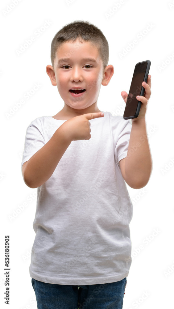 Dark haired little child using a smartphone very happy pointing with hand and finger Dark haired little child using a smartphone very happy pointing with hand and finger