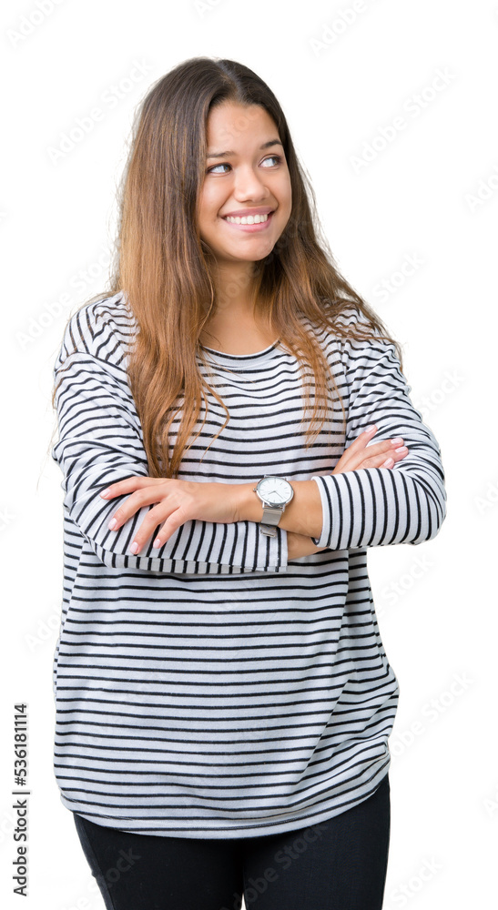 Young beautiful brunette woman wearing stripes sweater over isolated background smiling looking to the side with arms crossed convinced and confident Young beautiful brunette woman wearing stripes sweater over isolated background smiling looking to the side with arms crossed convinced and confident
