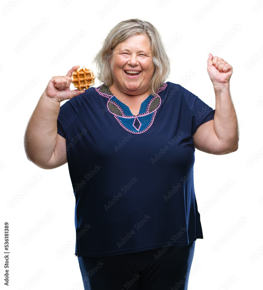 Senior plus size caucasian woman eating waffle over isolated background screaming proud and celebrating victory and success very excited, cheering emotion Senior plus size caucasian woman eating waffle over isolated background screaming proud and celebrating victory and success very excited, cheering emotion