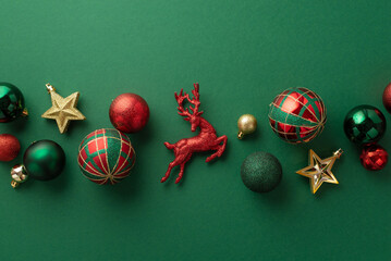 Christmas decorations concept. Top view photo of reindeer star ornaments gold green and red baubles on isolated green background