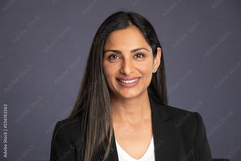 Studio headshots of beautiful Asian Indian woman in business attire on gray background. Studio headshots of beautiful Asian Indian woman in business attire on gray background.