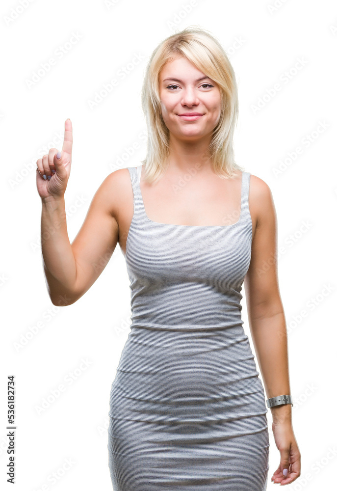 Young beautiful blonde woman over isolated background showing and pointing up with finger number one while smiling confident and happy. Young beautiful blonde woman over isolated background showing and pointing up with finger number one while smiling confident and happy.