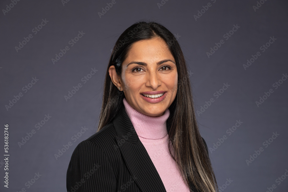 Studio headshots of beautiful Asian Indian woman in business attire on gray background. Studio headshots of beautiful Asian Indian woman in business attire on gray background.
