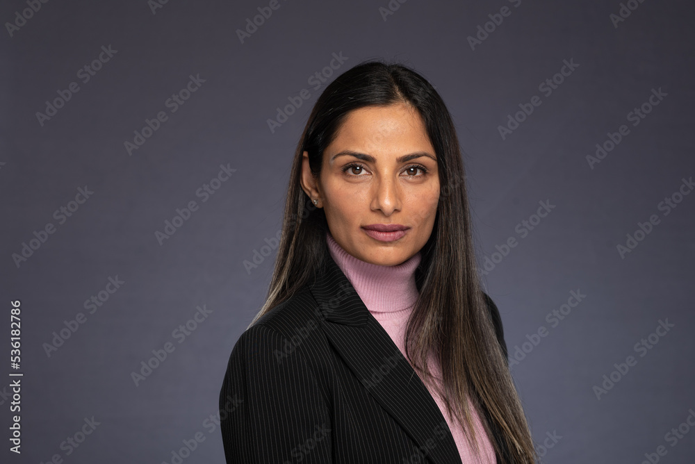 Studio headshots of beautiful Asian Indian woman in business attire on gray background. Studio headshots of beautiful Asian Indian woman in business attire on gray background.