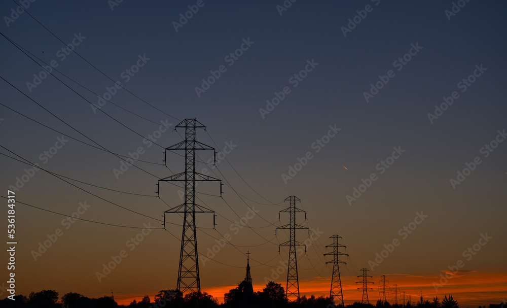 High Voltage Electricity Poles and wires on the sunset background