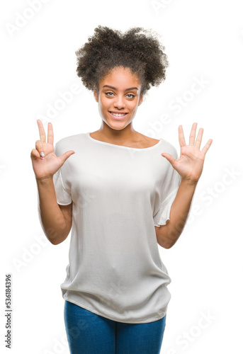 Young afro american woman over isolated background showing and pointing up with fingers number eight while smiling confident and happy.