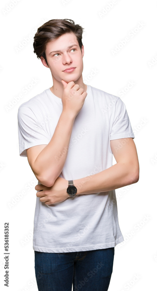 Young handsome man wearing casual white t-shirt over isolated background with hand on chin thinking about question, pensive expression. Smiling with thoughtful face. Doubt concept. Young handsome man wearing casual white t-shirt over isolated background with hand on chin thinking about question, pensive expression. Smiling with thoughtful face. Doubt concept.