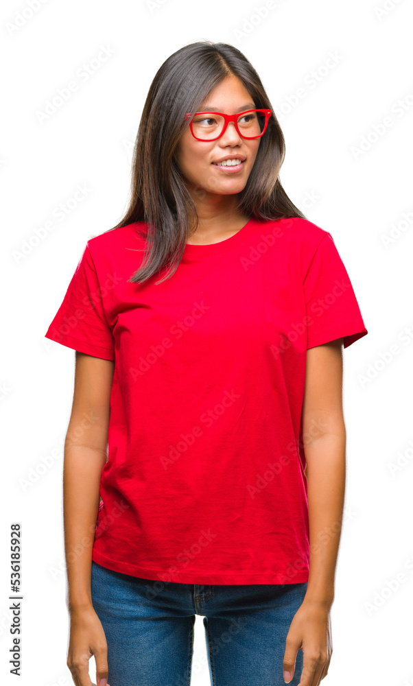 Young asian woman wearing glasses over isolated background looking away to side with smile on face, natural expression. Laughing confident. Young asian woman wearing glasses over isolated background looking away to side with smile on face, natural expression. Laughing confident.