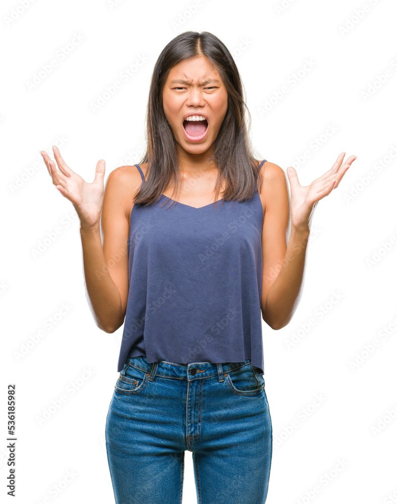 Young asian woman over isolated background celebrating mad and crazy for success with arms raised and closed eyes screaming excited. Winner concept Young asian woman over isolated background celebrating mad and crazy for success with arms raised and closed eyes screaming excited. Winner concept