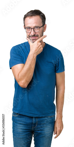 Handsome middle age hoary senior man wearin glasses over isolated background looking confident at the camera with smile with crossed arms and hand raised on chin. Thinking positive.