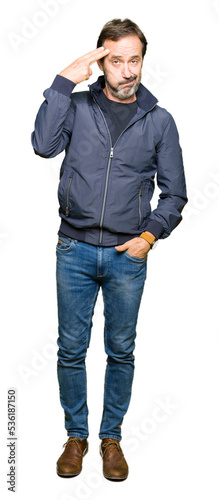Middle age handsome man wearing a jacket Shooting and killing oneself pointing hand and fingers to head, suicide gesture. © Krakenimages.com