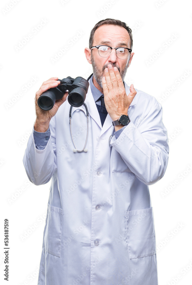 Middle age senior hoary doctor man looking through binoculars isolated background cover mouth with hand shocked with shame for mistake, expression of fear, scared in silence, secret concept Middle age senior hoary doctor man looking through binoculars isolated background cover mouth with hand shocked with shame for mistake, expression of fear, scared in silence, secret concept