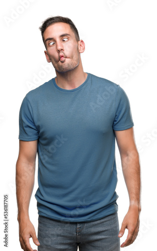 Handsome young casual man making fish face with lips  crazy and comical gesture. Funny expression.