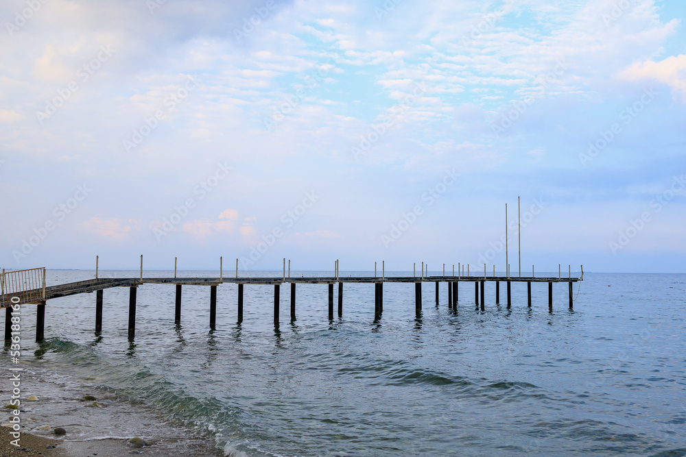 Obraz premium Old pier on the public central beach. Background with copy space