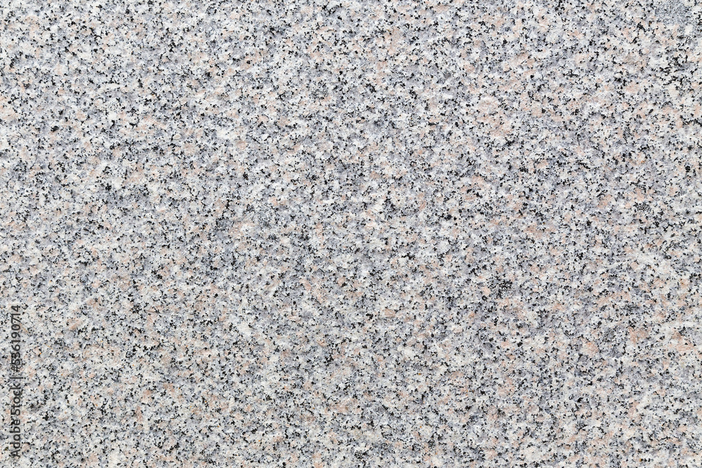 Rough granite stone, abstract, background texture from an external wall of a building. Flecks of black, grey, brown and white on an unpolished slab. Rough granite stone, abstract, background texture from an external wall of a building. Flecks of black, grey, brown and white on an unpolished slab.