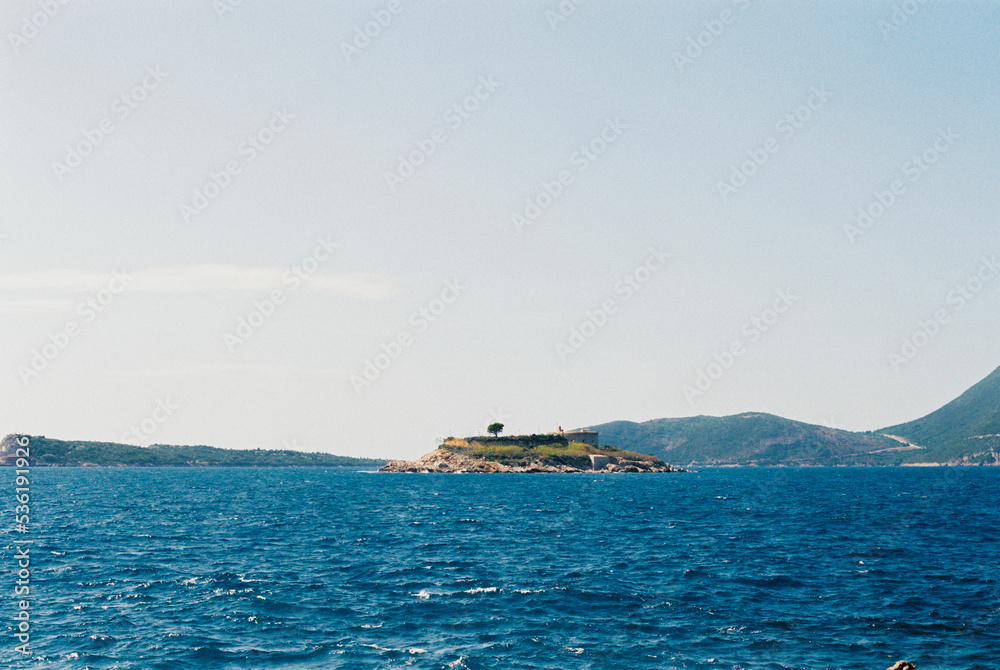 Lustica peninsula with Arza fortress against the backdrop of mountains. Montenegro