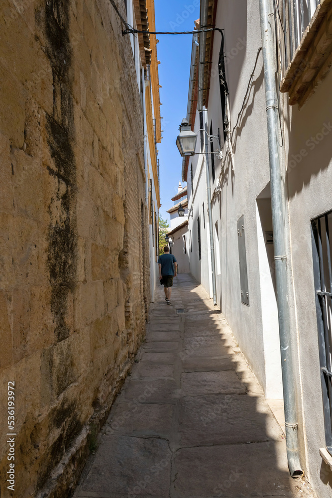A lonely tourist in the Jewish Quarter of Cordoba, Spain