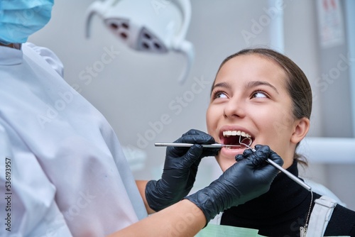 Young teenage female at dental checkup in clinic