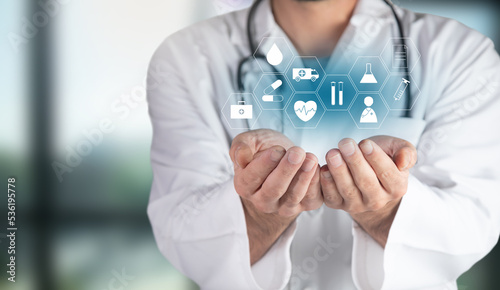 Doctor holding medical icons in hand