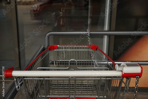 New empty metal shopping cart outdoors, closeup