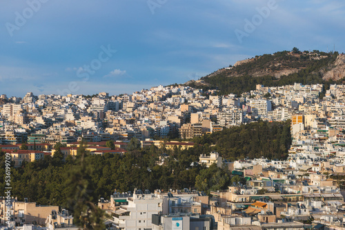 Athens, Attica, beautiful super-wide angle view of Athens, Greece, with Acropolis, Mount Lycabettus, mountains and scenery beyond the city, seen from Strefi Hill park in Exarcheia neighbourhood © tsuguliev
