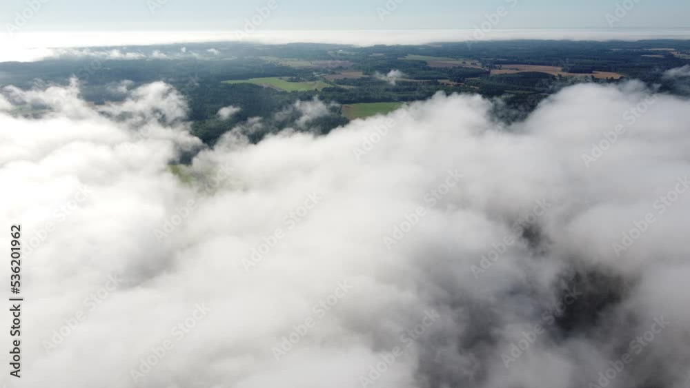 Mist fog clouds from above aerial view over seasonal autumn forest low morning sunlight Mist fog clouds from above aerial view over seasonal autumn forest low morning sunlight