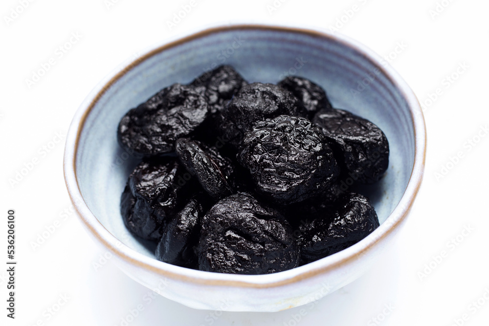 Dried prunes on white background