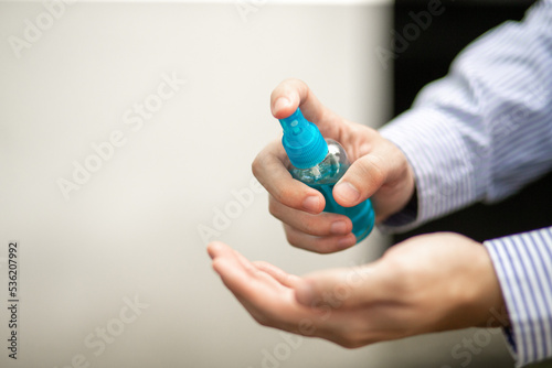 Man's hand holding Ethyl Alcohol spray. Spray on hand to kill germs for safety.