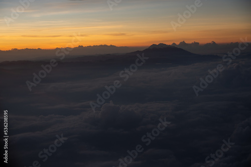 View from an airplane of sunset sunbeam over clouds