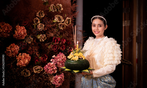 Thai woman wearing thai traditional dresses modern hold kratong,Loy Krathong Traditional Festival by bring Krathong to float in Loy kratong day of Thailand is religion travel concept. photo