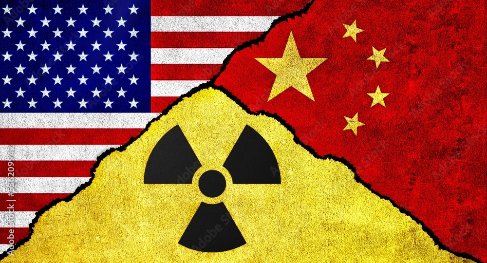 Flags of USA, China and Nuclear symbol together on a textured wall