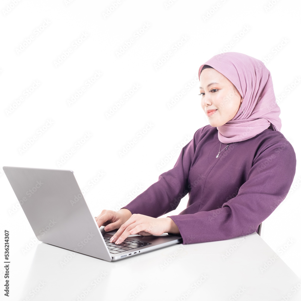 Young beautiful Asian Islamic businesswoman wearing hijab holding a tablet computer. Women empowerment and leadership concept. Isolated on white background Young beautiful Asian Islamic businesswoman wearing hijab holding a tablet computer. Women empowerment and leadership concept. Isolated on white background