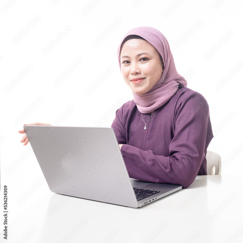Young beautiful Asian Islamic businesswoman wearing hijab holding a tablet computer. Women empowerment and leadership concept. Isolated on white background Young beautiful Asian Islamic businesswoman wearing hijab holding a tablet computer. Women empowerment and leadership concept. Isolated on white background