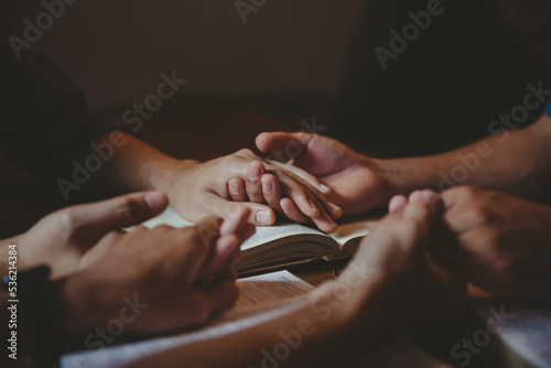 Christian group are praying to god with the bible and sharing the gospel. Concept of faith for god. photo