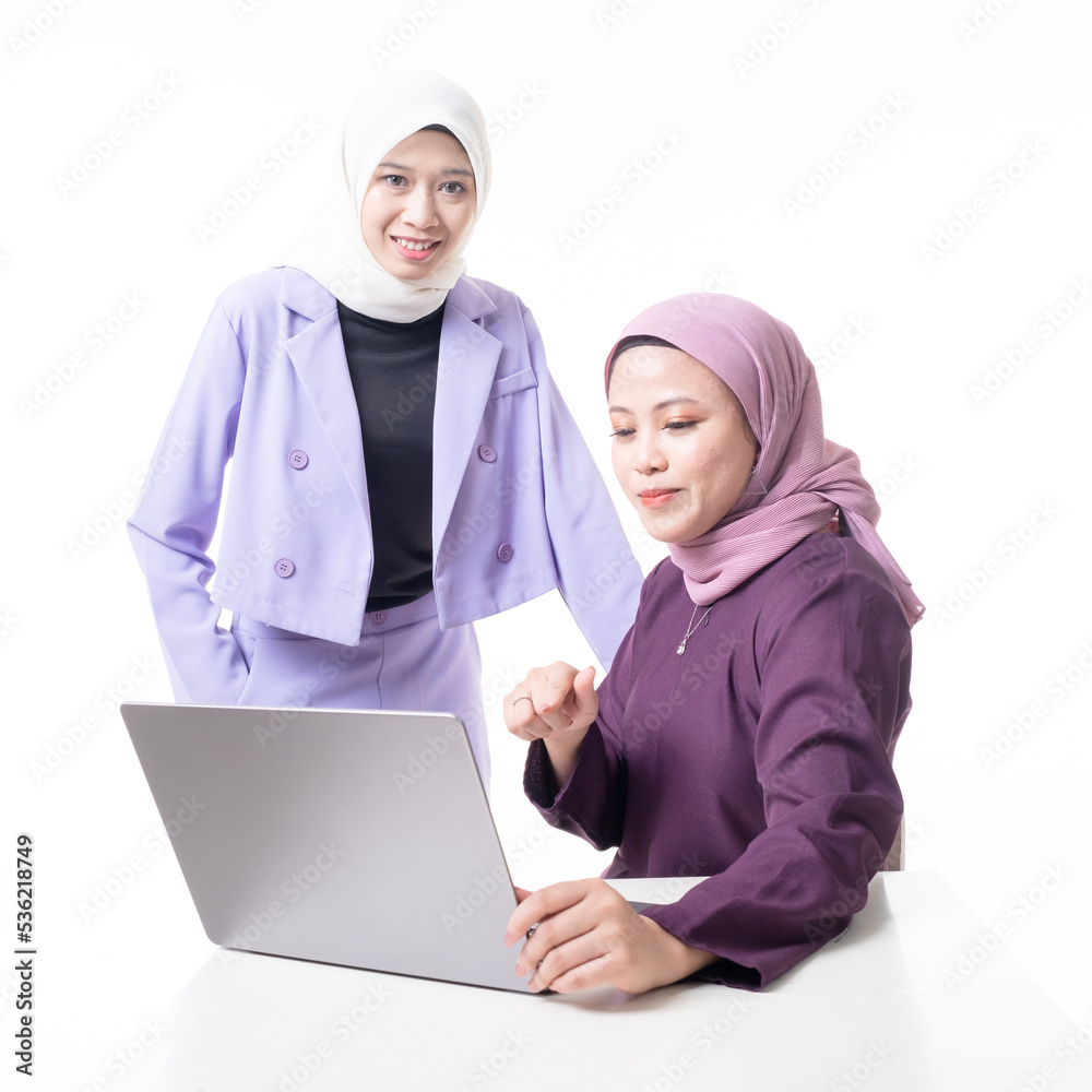 Muslim colleagues wearing hijab smiling and communicating at workplace. Teammates discussing about work in office. Friendly businesswomen discussing project ideas. Isolated on white background