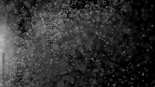 3D rendering of dust particles with bokeh on black background.