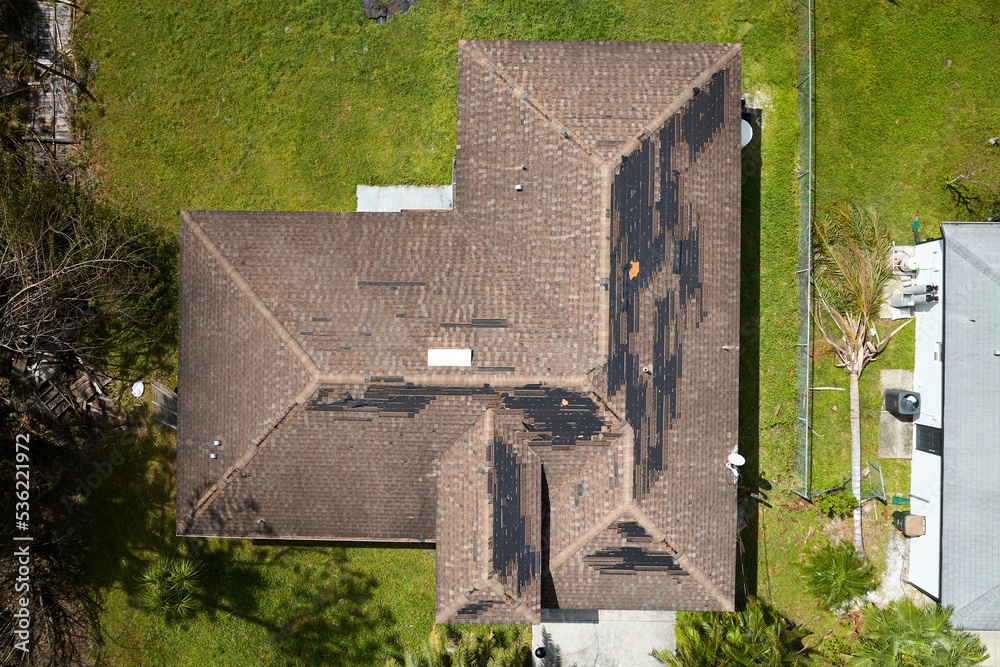 Hurricane Ian destroyed house roof in Florida residential area. Natural ...